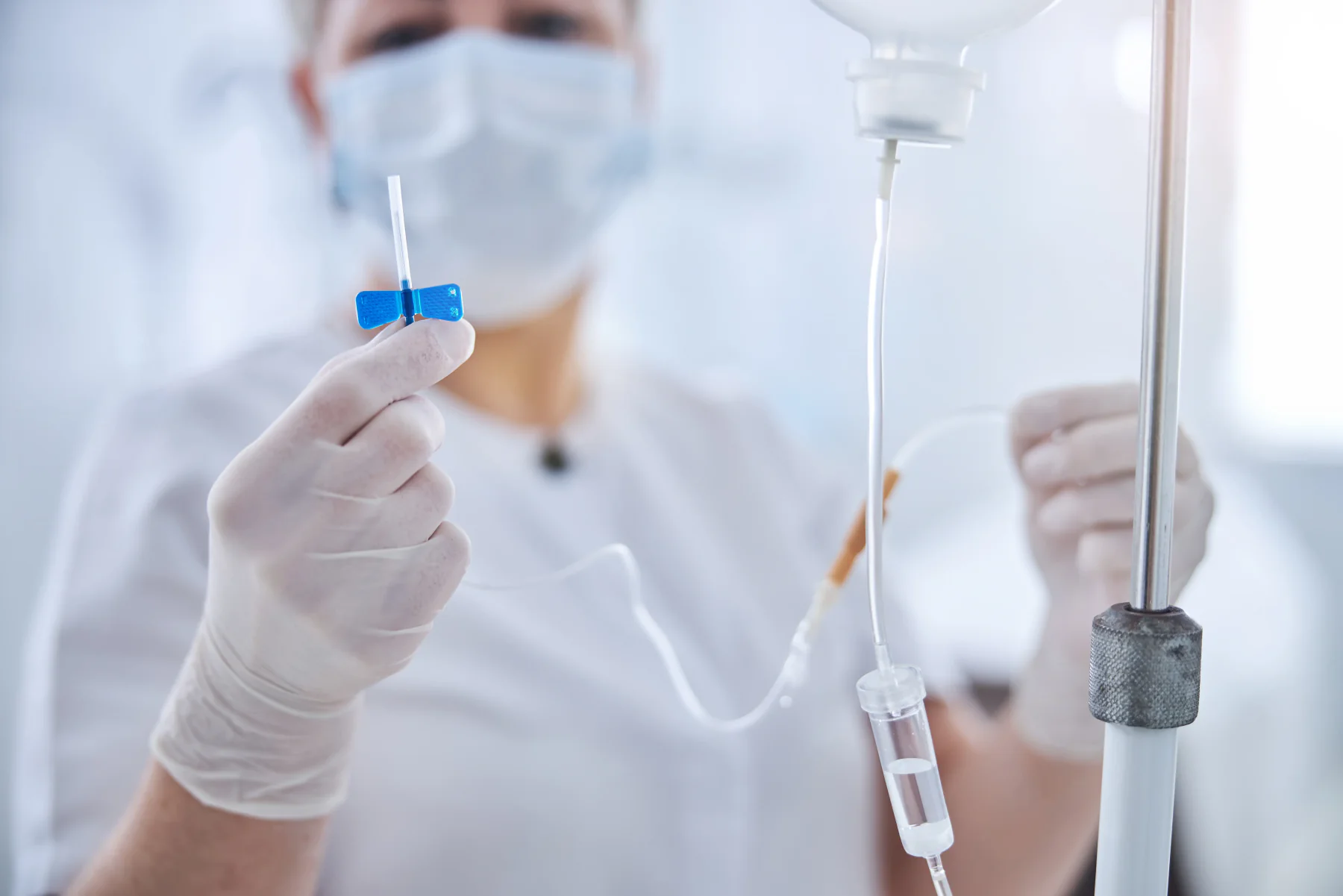 Healthcare professional preparing an IV catheter and infusion set